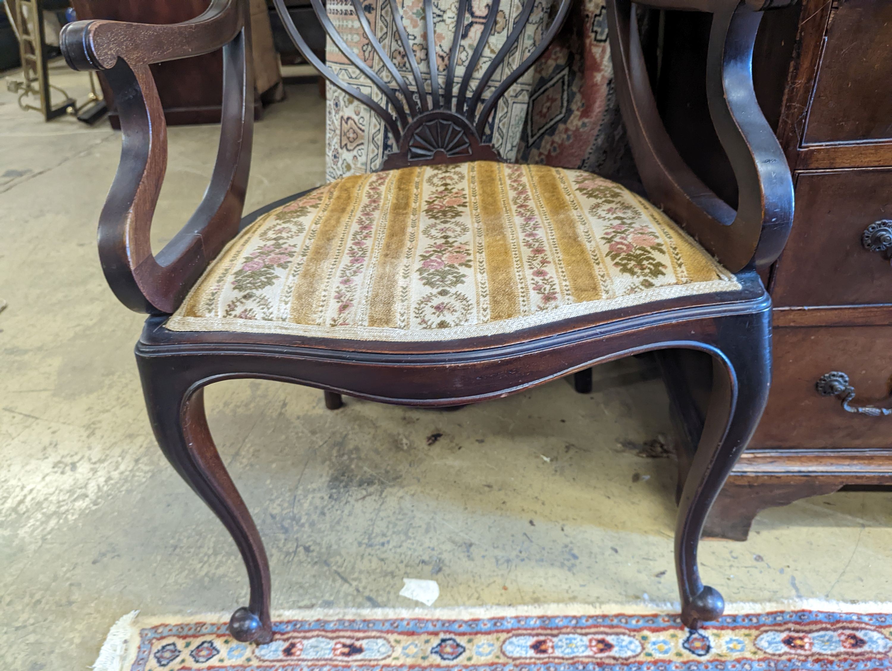 A late Victorian carved mahogany elbow chair